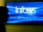 A man walks past a billboard of Infosys Technologies Ltd's office in Bangalore, October 10, 2003. (Jagadeesh NV/Reuters)