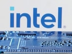 Intel layoffs: Intel logo is seen near computer motherboard.