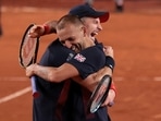Andy Murray of Britain and Daniel Evans of Britain celebrate after winning their match against Sander Gille of Belgium and Joran Vliegen of Belgium.