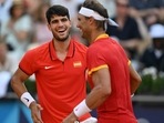 Spain's Carlos Alcaraz (L) playing with Spain's Rafael Nadal reacts while playing Netherlands' Tallon Griekspoor and Netherlands' Wesley Koolhof during their men's doubles second round tennis match Spain's Carlos Alcaraz (L) playing with Spain's Rafael Nadal reacts while playing Netherlands' Tallon Griekspoor and Netherlands' Wesley Koolhof during their men's doubles second round tennis match