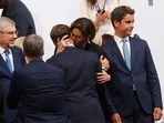 French minister of Sport Amélie Oudéa-Castéra (CR) hugs France's President Emmanuel Macron (CL) at the Trocadero following the opening ceremony of the Paris 2024 Olympic Games in Paris on July 26, 2024. (Photo by Odd ANDERSEN / AFP)(AFP) French minister of Sport Amélie Oudéa-Castéra (CR) hugs France's President Emmanuel Macron (CL) at the Trocadero following the opening ceremony of the Paris 2024 Olympic Games in Paris on July 26, 2024. (Photo by Odd ANDERSEN / AFP)(AFP)