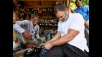 Rahul Gandhi with a cobbler during his visit to Sultanpur on July 26, 2024 (PTI File) Rahul Gandhi with a cobbler during his visit to Sultanpur on July 26, 2024 (PTI File)