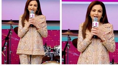 Nita Ambani wore a beige co-ord set with swirling patterns. Keeping her look low-key, she accesorised only with a watch. She felicitated shooter Sarabjot Singh after winning a bronze medal. (Instagram) Nita Ambani wore a beige co-ord set with swirling patterns. Keeping her look low-key, she accesorised only with a watch. She felicitated shooter Sarabjot Singh after winning a bronze medal. (Instagram)