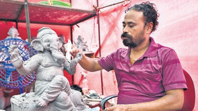 Mumbai, India - July 30, 2024: Artist Nilesh Niwate is making eco-friendly Ganesh idols at his workshop in the Chinchpokli area of Mumbai. The BMC provides free space and shadu clay to artists who making eco-friendly Ganesh idols., in Mumbai, India, July 30, 2024. (Photo by Raju Shinde/ Hindustan Times) (Hindustan Times) Mumbai, India - July 30, 2024: Artist Nilesh Niwate is making eco-friendly Ganesh idols at his workshop in the Chinchpokli area of Mumbai. The BMC provides free space and shadu clay to artists who making eco-friendly Ganesh idols., in Mumbai, India, July 30, 2024. (Photo by Raju Shinde/ Hindustan Times) (Hindustan Times)