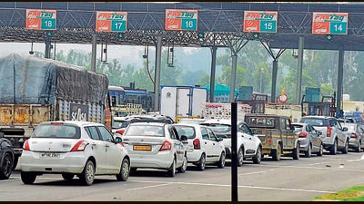 Vehicles crossing from Ladhowal Toll barrier in a row after paying toll fee after the police vacated the area from farmer unions who had initiated a sit-in since June 16 against increased toll fee. (Gurpreet Singh/Hindustan Times) Vehicles crossing from Ladhowal Toll barrier in a row after paying toll fee after the police vacated the area from farmer unions who had initiated a sit-in since June 16 against increased toll fee. (Gurpreet Singh/Hindustan Times)