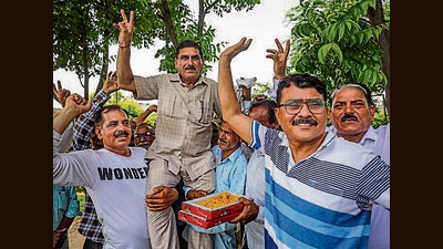 West Pakistani Refugees (WPRs) celebrate after the J&K administration granted proprietary rights to WPRs for land in the union territory, in Jammu on Wednesday. (PTI) West Pakistani Refugees (WPRs) celebrate after the J&K administration granted proprietary rights to WPRs for land in the union territory, in Jammu on Wednesday. (PTI)