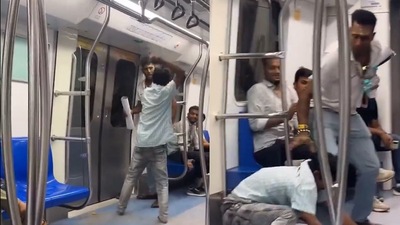 Delhi metro: The man hit the other passenger with his slipper, leading to a physical fight. Delhi metro: The man hit the other passenger with his slipper, leading to a physical fight.