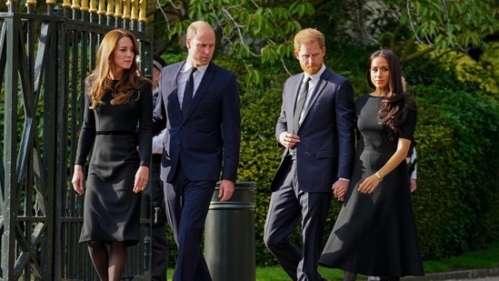 Britain's Prince William, second left, Kate, Princess of Wales, left, Britain's Prince Harry, second right, and Meghan, Duchess of Sussex view the floral tributes for the late Queen Elizabeth II outside Windsor Castle, in Windsor, England on Sept. 10, 2022. (AP Photo/Martin Meissner, File)(AP)