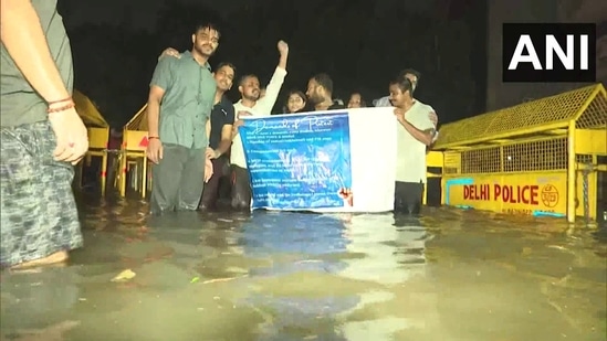 Amidst heavy downpour students protesting against deaths of UPSC aspirants in Old Rajender Nagar on Wednesday. (ANI)(ANI)