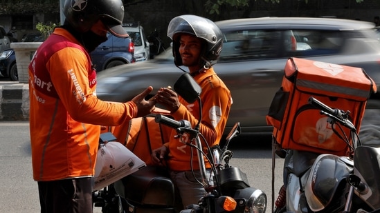 Gig workers prepare to deliver orders outside Swiggy's grocery warehouse at a market area in New Delhi, India, May 6, 2024. REUTERS/Priyanshu Singh (REUTERS)