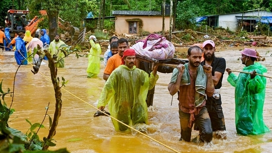 Relief personnel carry the body of a victim, during a search and rescue operation at a site following landslides in Wayanad.(AFP) Relief personnel carry the body of a victim, during a search and rescue operation at a site following landslides in Wayanad.(AFP)