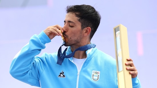 Gold medallist Jose Torres Gil of Argentina celebrates with his medal(REUTERS)