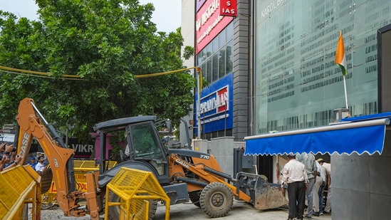 An excavator during an anti-encroachment drive in the Old Rajinder Nagar area, in New Delhi.(PTI)