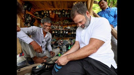 Rahul Gandhi with a cobbler during his visit to Sultanpur on July 26, 2024 (PTI File)