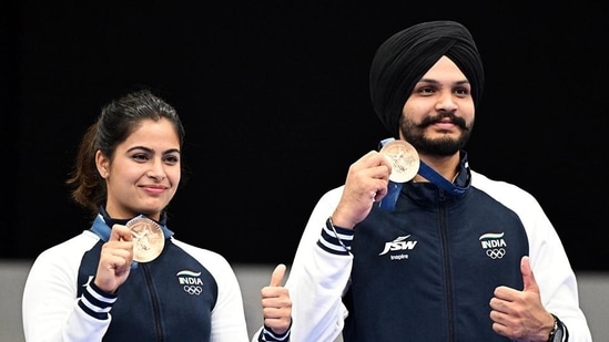 Shooter Manu Bhaker and Sarabjot Singh pose for a photograph with their Bronze medals on winning the 10m Air Pistol Mixed Team event at the Olympic Games Paris 2024, in Paris on Tuesday.(HT_PRINT)
