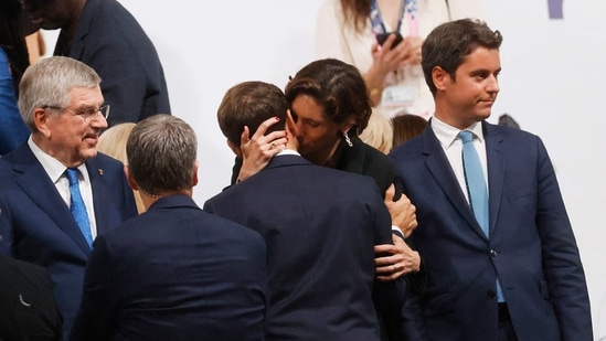 French minister of Sport Amélie Oudéa-Castéra (CR) hugs France's President Emmanuel Macron (CL) at the Trocadero following the opening ceremony of the Paris 2024 Olympic Games in Paris on July 26, 2024. (Photo by Odd ANDERSEN / AFP)(AFP)