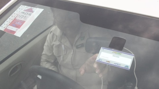 Latest news on August 1, 2024: A man points to the FASTag on his vehicle's windshield, at the toll office at Kherki-Daula toll plaza, in Gurugram, on November 27, 2019 (Yogendra Kumar/HT PHOTO)