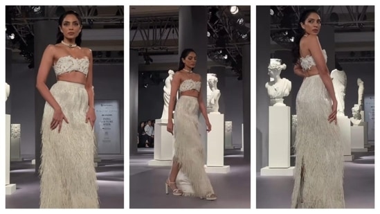 Sobhita Dhulipala stunned in Rimzim Dadu's outfit at India Couture Week. She wore a pristine, white ensemble. Her ensemble featured a side slit maxi skirt had tussles, an off-shoulder bralette. She finished her look with matching heels and a choker necklace.  (Instagram/@fdciofficial)