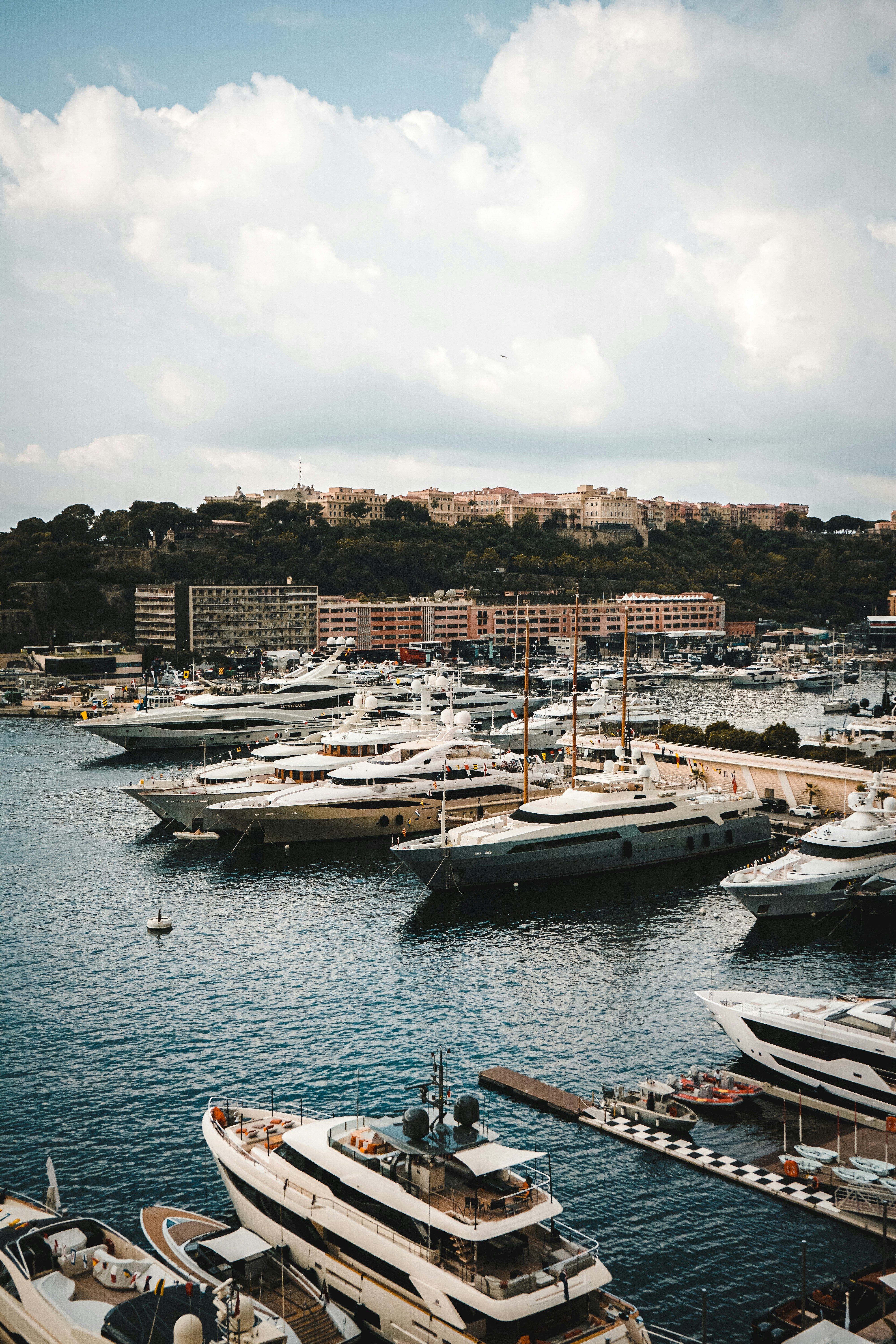 Monaco harbour has several luxury vessels docked.