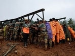 Army personnel and volunteers lift a portion of a bridge during its re-construction, after landslides hit Chooralmala in Wayanad district.