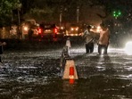 People wade through a waterlogged road during rain at Jangpura area, in New Delhi, Wednesday, July 31, 2024. (PTI) People wade through a waterlogged road during rain at Jangpura area, in New Delhi, Wednesday, July 31, 2024. (PTI)