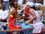 Qinwen Zheng of China and Iga Swiatek of Poland shake hands after their match