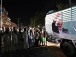 Activists and supporters of Pakistan's Jamaat-e-Islami (JI) attend an absentee funeral prayers for slain Hamas political leader Ismail Haniyeh, next to his poster in Rawalpindi on July 31, 2024, following his assassination in an air strike in Tehran. (Photo by Aamir QURESHI / AFP)(AFP) Activists and supporters of Pakistan's Jamaat-e-Islami (JI) attend an absentee funeral prayers for slain Hamas political leader Ismail Haniyeh, next to his poster in Rawalpindi on July 31, 2024, following his assassination in an air strike in Tehran. (Photo by Aamir QURESHI / AFP)(AFP)