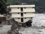 Part of a three storey building is washed away in flash floods in the Uttarkashi district, Uttarakhand. (AP/FILE) Part of a three storey building is washed away in flash floods in the Uttarkashi district, Uttarakhand. (AP/FILE)