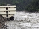 Part of a three storey building is washed away in flash floods in the Uttarkashi district, Uttarakhand. (AP/FILE) Part of a three storey building is washed away in flash floods in the Uttarkashi district, Uttarakhand. (AP/FILE)