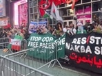 Anti-Israel protesters hold up portrait of Ismail Haniyeh, wave pro-terror flag in Times Square (@SpyderMonkey0_0/X) Anti-Israel protesters hold up portrait of Ismail Haniyeh, wave pro-terror flag in Times Square (@SpyderMonkey0_0/X)