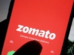 Zomato Q1 results: The logo of Indian food delivery company Zomato is seen on its app on a mobile phone displayed in front of its company website.(REUTERS)