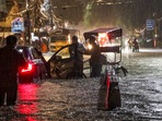 New Delhi: People wade through a waterlogged road during rain at Jangpura area, in New Delhi, Wednesday, July 31, 2024.