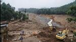 Rescuers search through mud and debris for a third day after landslides set off by torrential rains in Wayanad district. (AP) Rescuers search through mud and debris for a third day after landslides set off by torrential rains in Wayanad district. (AP)