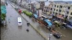 Vehicles move through a waterlogged road after rains, in Jaipur. (PTI photo)