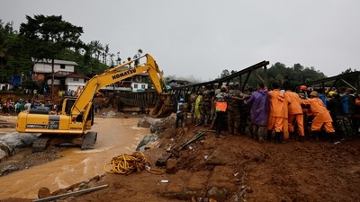 An excavator along with army personnel and volunteers lift a portion of a bridge during its re-construction after landslides hit Chooralmala in Wayanad district. (Reuters)