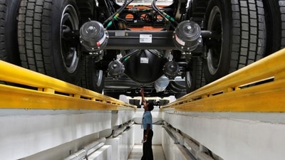 An employee inspects the engine of a BharatBenz truck inside Daimler's factory in Oragadam in Tamil Nadu. (Reuters)