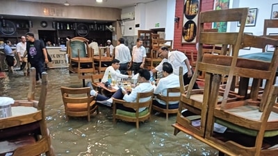 In Delhi's flooded Press Club, it was business as usual. (X/@bijendrasingh) In Delhi's flooded Press Club, it was business as usual. (X/@bijendrasingh)