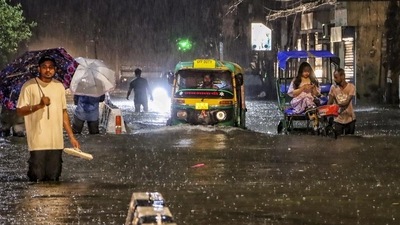 A scene from the waterlogged road in south Delhi's Jangpura. (Photo: PTI) A scene from the waterlogged road in south Delhi's Jangpura. (Photo: PTI)