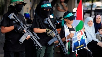 Masked boys hold machine gun toys during a protest in the southern port city of Sidon, Lebanon, Wednesday, July 31, 2024, to condemn the killing of Hamas political chief Ismail Haniyeh. (AP) Masked boys hold machine gun toys during a protest in the southern port city of Sidon, Lebanon, Wednesday, July 31, 2024, to condemn the killing of Hamas political chief Ismail Haniyeh. (AP)