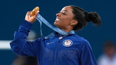 Simone Biles, of the United States, celebrates after winning the gold medal during the women's artistic gymnastics all-around finals in Bercy Arena (AP) Simone Biles, of the United States, celebrates after winning the gold medal during the women's artistic gymnastics all-around finals in Bercy Arena (AP)
