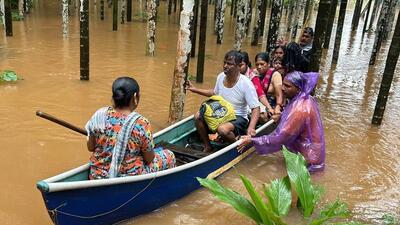 Rescue officials help stranded people in the flooded Uttara Kannada district on Thursday (HT Photo)