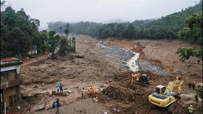 Rescuers search through mud and debris for a third day after landslides set off by torrential rains in Wayanad district. (AP) Rescuers search through mud and debris for a third day after landslides set off by torrential rains in Wayanad district. (AP)