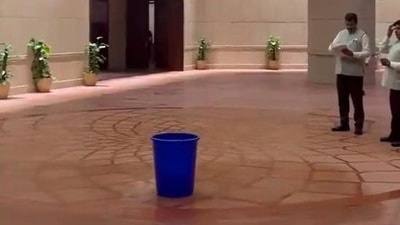 Water dripping from the ceiling of the new Parliament building being collected in a bucket. (Photo from X) Water dripping from the ceiling of the new Parliament building being collected in a bucket. (Photo from X)