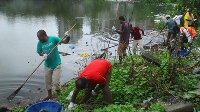 Volunteers collect garbage from the waterbody near the Charkop mangroves. (HT Photo)