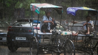 A rickshaw puller seeks shelter after sudden rains lashed Delhi-NCR. Rain clouds convereged, leading extremely intense rainfall at over 50mm of rainfall in an hour. ((Photo by Sunil Ghosh / Hindustan Times)) A rickshaw puller seeks shelter after sudden rains lashed Delhi-NCR. Rain clouds convereged, leading extremely intense rainfall at over 50mm of rainfall in an hour. ((Photo by Sunil Ghosh / Hindustan Times))