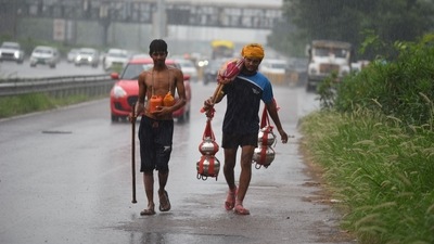 Kanwariyas on their way amid heavy rain at National Highway-48 near IFFCO Chowk, in Gurugram. Devotees could be seen resting at roadside temples to escape the intensity of rains. ((Photo by Parveen Kumar/Hindustan Times)) Kanwariyas on their way amid heavy rain at National Highway-48 near IFFCO Chowk, in Gurugram. Devotees could be seen resting at roadside temples to escape the intensity of rains. ((Photo by Parveen Kumar/Hindustan Times))