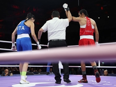 Imane Khelif of Algeria has her hand raised after winning her fight against Angela Carini of Italy (REUTERS)