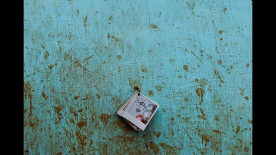 A birthday greeting card hangs on a wall of a destroyed home, covered with mud stains after several landslides hit the hills in Wayanad district. (REUTERS)