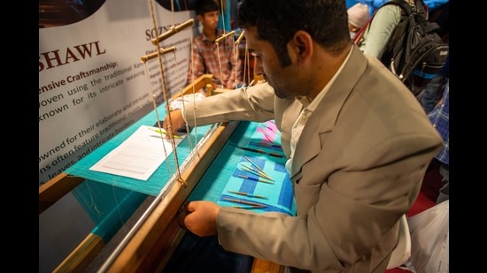 A handloom weaver showcasing traditional Kani shawl weaving during the 42nd India International Trade Fair in Pragati Maidan on 15 November 2023. (Anupama Yadav/Shutterstock)