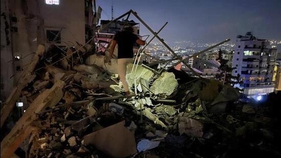 A man inspects a destroyed building that was hit by an Israeli airstrike in the southern suburbs of Beirut, Lebanon. (AP photo)